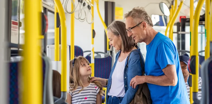 Grandparents with girl on bus