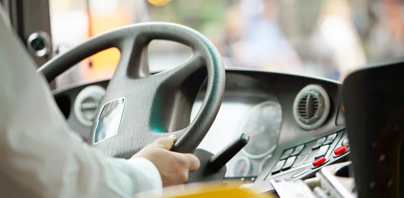 Close up of bus driver at wheel