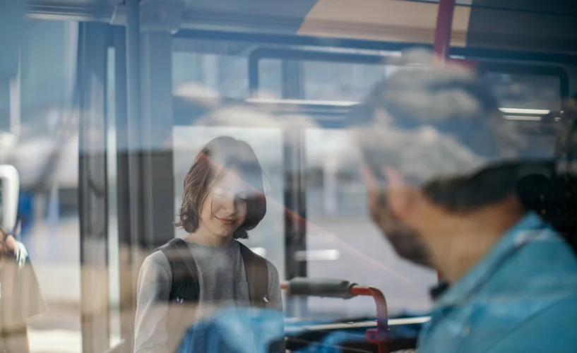 Young passenger boarding a bus