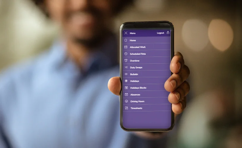 A man holding a smartphone displaying bus driver app OmniENGAGE